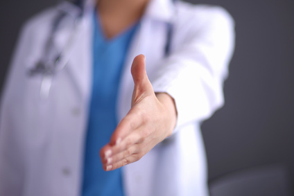 A female doctor&amp;amp;amp;amp;#39;s handshake , isolated on grey background